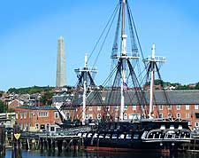 Picture of the USS Constitution, with the Bunker Hill Monument in the background