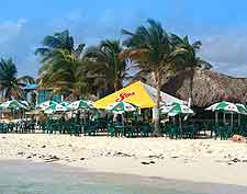 Photo showing beachfront cafe, with parasols