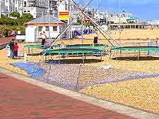 View of the beach and seasonal children's trampolines