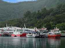 Image showing cruise boats and ferries lined up at Milford Sound