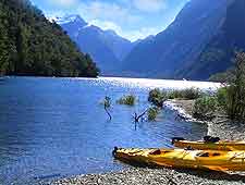 Photo of kayaks laid on the shore of Milford Sound