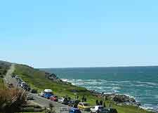 Cars parked overlooking Newquay cliffs