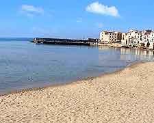 Further view of sandy beachfront in the resort village of Cefalu