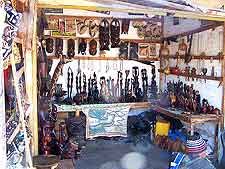 Photo of gift shop in Banjul, selling art-related souvenirs and wood carvings