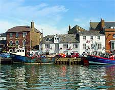 Summer image of the harbour, showing the George Inn