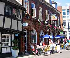 Photo of al fresco cafe tables and Tudor buildings